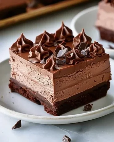 Delicious Chocolate Mousse Brownies garnished with chocolate shavings