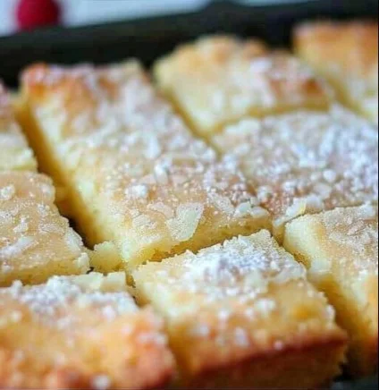 Delicious slice of French Butter Cake topped with fresh berries and cream.