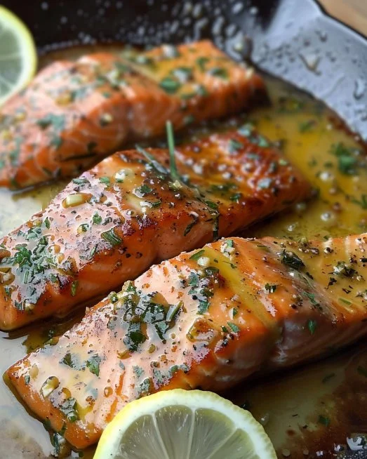Garlic Butter Salmon 2 Delicious Garlic Butter Salmon served with lemon slices and fresh herbs