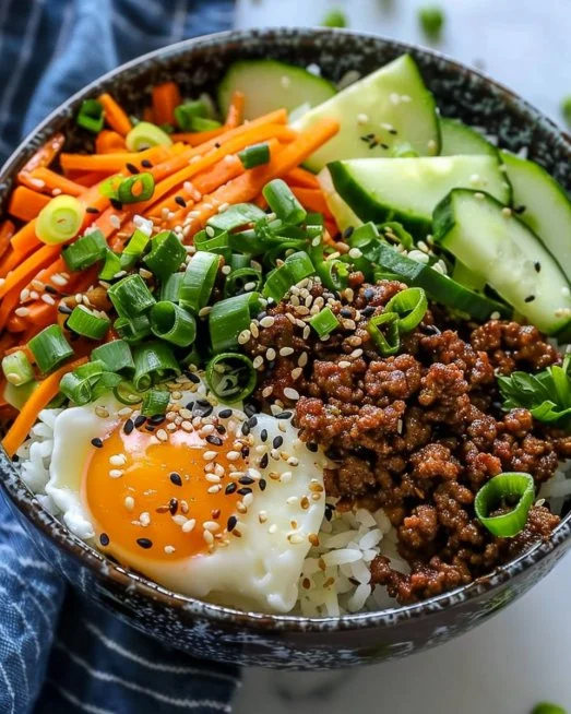 Korean Ground Beef Bowl 2 Delicious Korean Ground Beef Bowl garnished with vegetables and served over rice