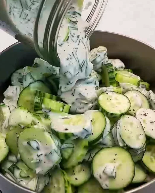 TZATZIKI INSPIRED CUCUMBER SALAD. in 2025 2 Tzatziki inspired cucumber salad served in a bowl with fresh herbs and yogurt dressing