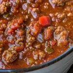 Bowl of low-carb Paleo chili topped with fresh herbs and avocado