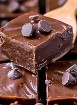 Old-Fashioned Chocolate Fudge 3 Delicious old-fashioned chocolate fudge pieces on a plate.