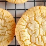 Freshly baked soft and chewy classic vanilla cookies on a cooling rack